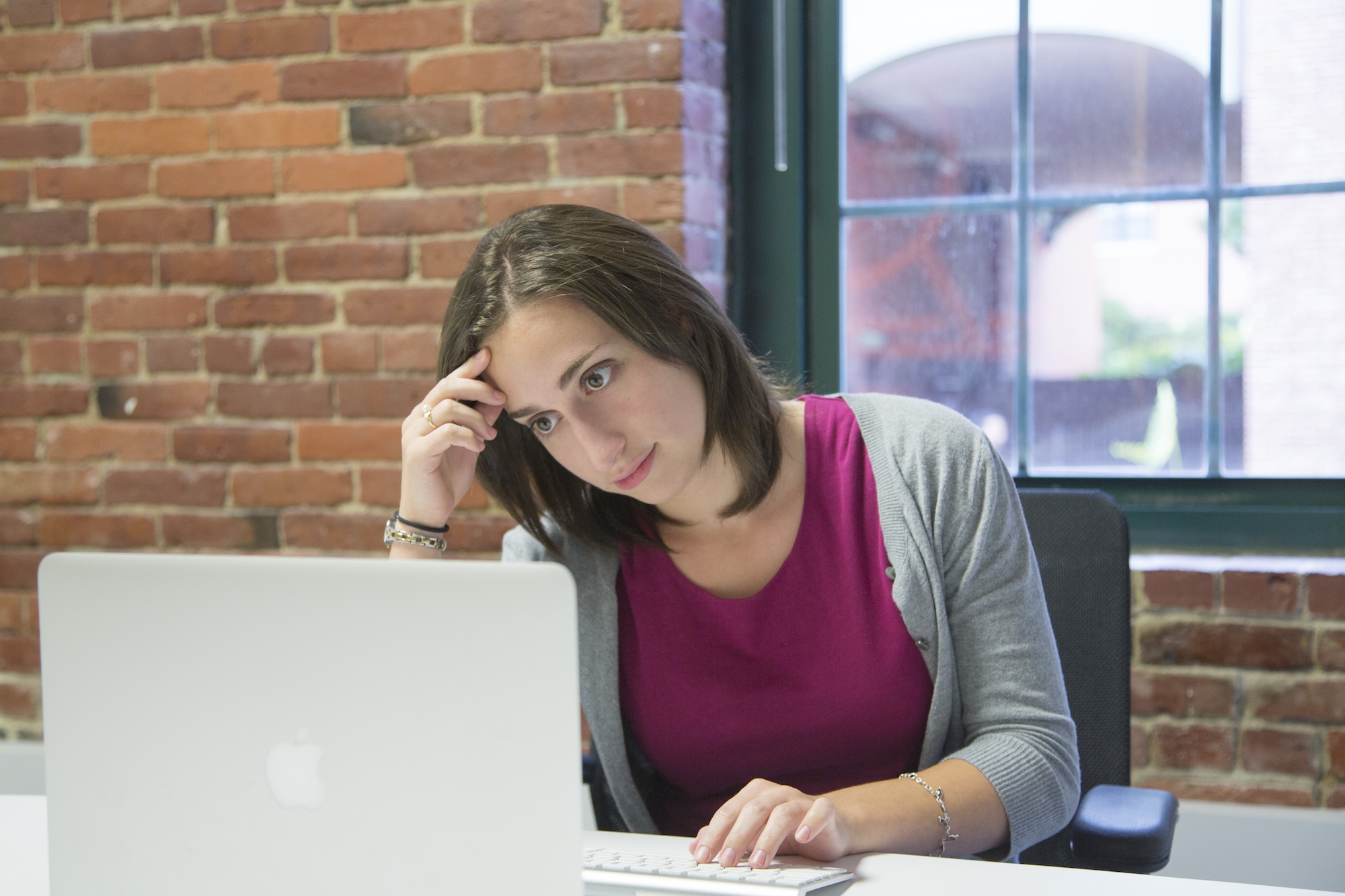 annoyed woman staring into laptop screen