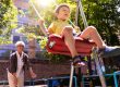 kid swinging at park with grandma